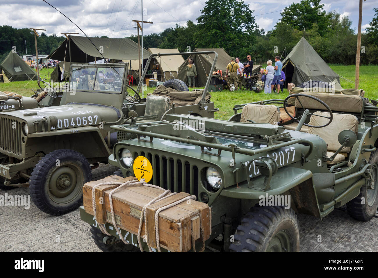 World War Two US Army Willys MB jeeps, four-wheel drive utility vehicles in front of WW2 reenactors' field camp at militaria fair Stock Photo