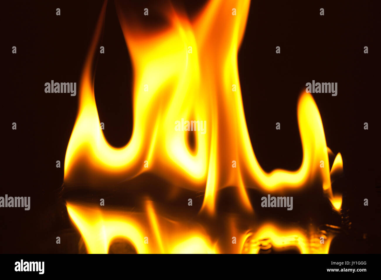 Open flame with reflection on black glass Stock Photo Alamy