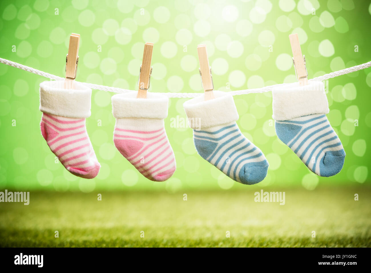 Pair Of Two Baby Sock Hanging On Rope Using Wooden Clip Stock Photo - Alamy