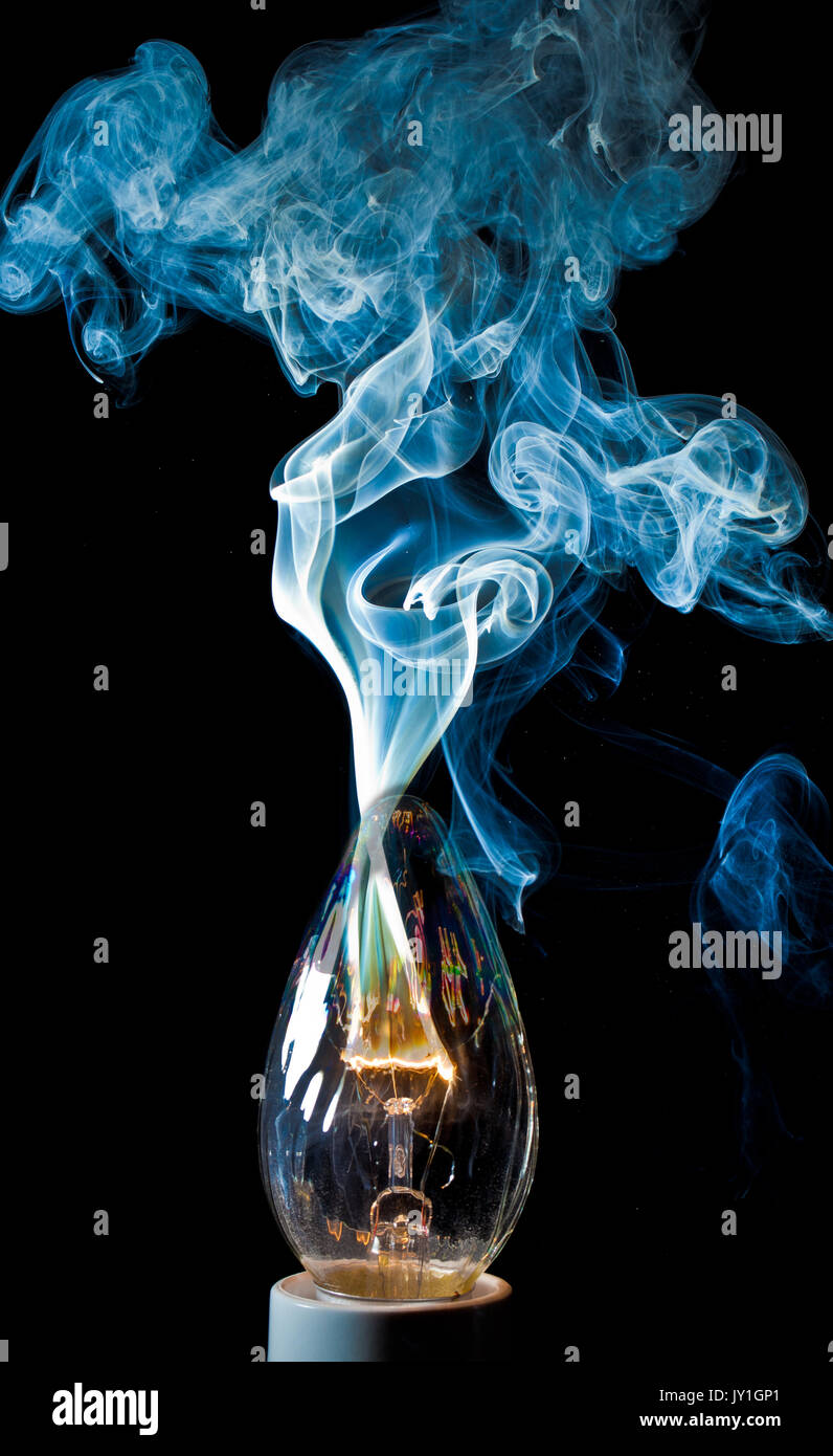 "Death By Electricity" An electrical element in a light bulb igniting and burning out Stock