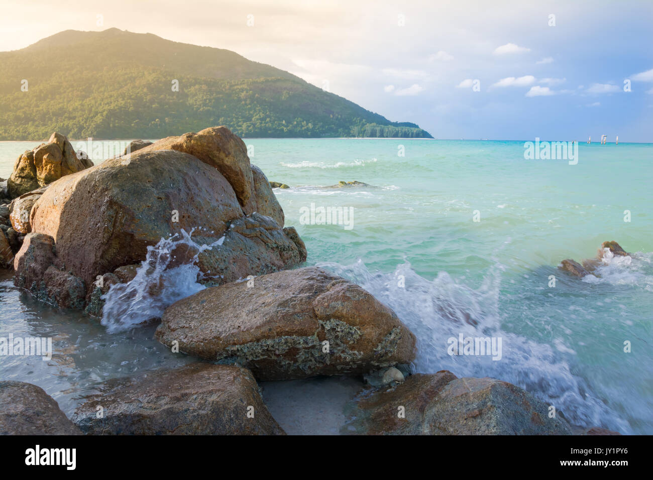 Splash waves hit rocks with the beautiful sunlight and sky Stock Photo ...