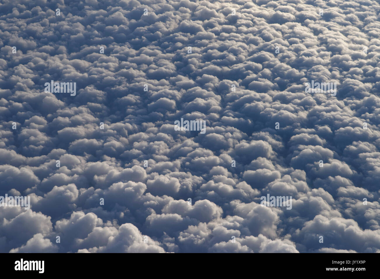 Sight through airplane window on clouds, flight over Namibia, Africa Stock Photo
