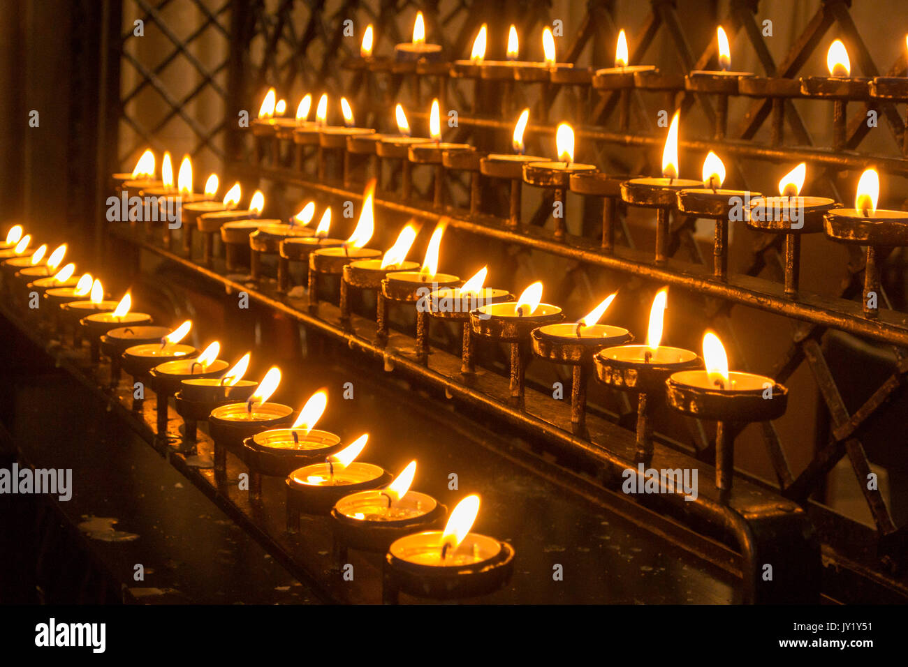 Rows of burning church candles Stock Photo Alamy