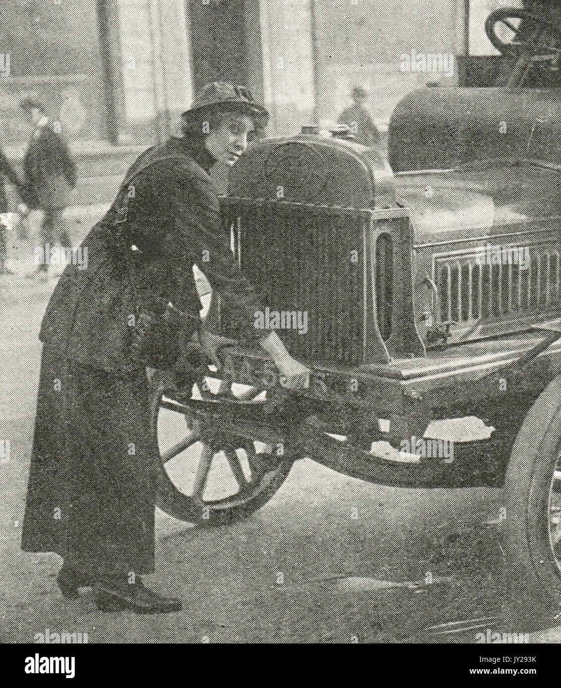 Woman driver crank starting vehicle, WW1 Stock Photo