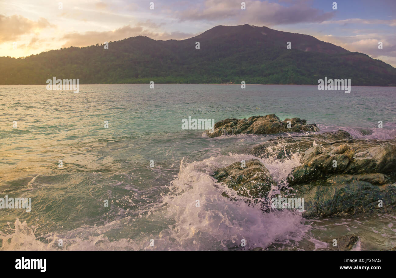 Splash waves hit rocks with the beautiful sunlight and sky Stock Photo ...