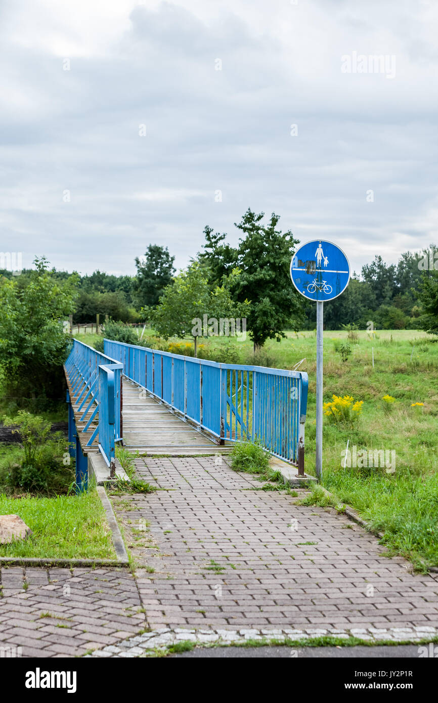 an Pedestrian or bicycle bridge with a signboard Stock Photo - Alamy