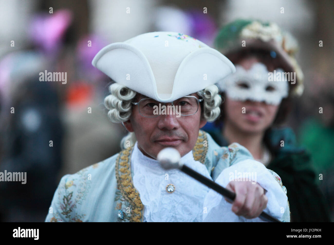 Venice,Italy,February 26th 2011:Image of a man wearing a medieval costume with a stick in an agressive position during the Carnival of Venice nights.T Stock Photo