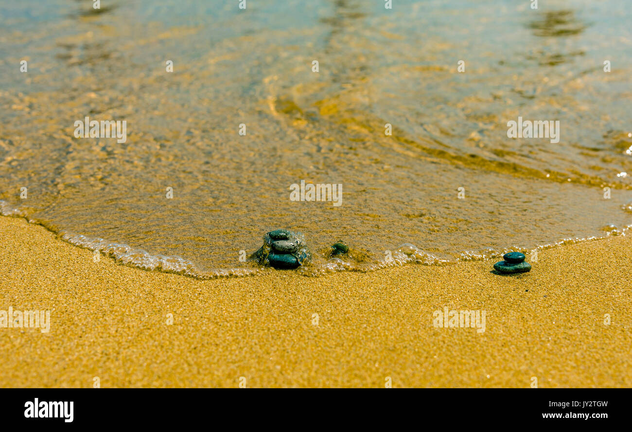 Balance stone on river coast Sand water pebbles relax Stock Photo
