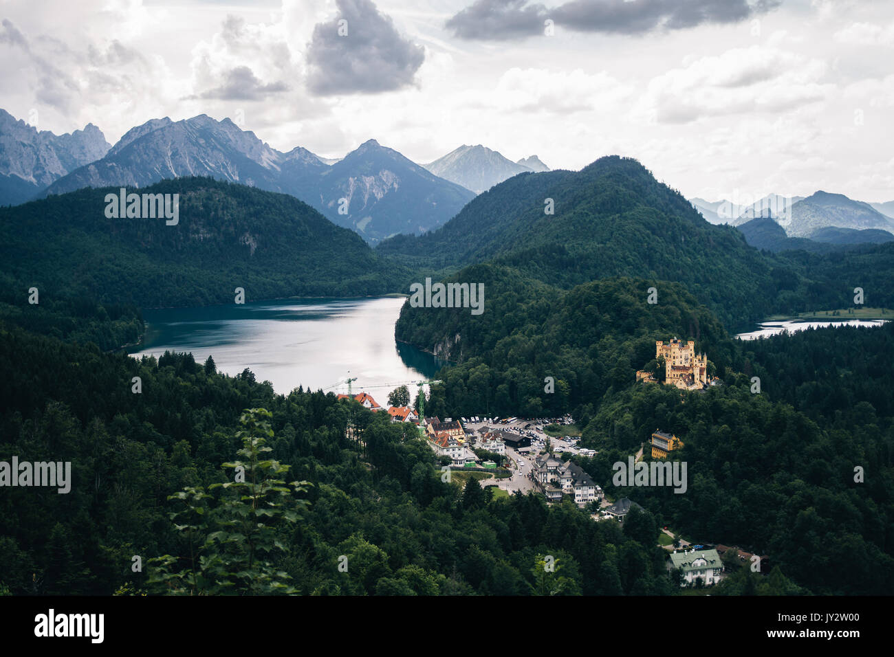 Landscape on the Alps and the Alpsee mountain lake with Hohenschwangau and its castle in the foreground. Stock Photo