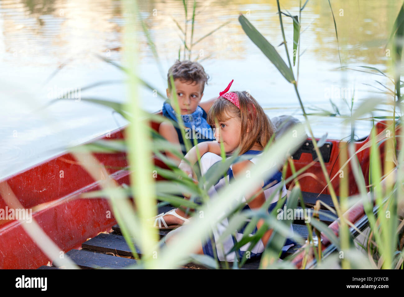 Family and friends summer vacation. Children ride on a boat outdoors ...