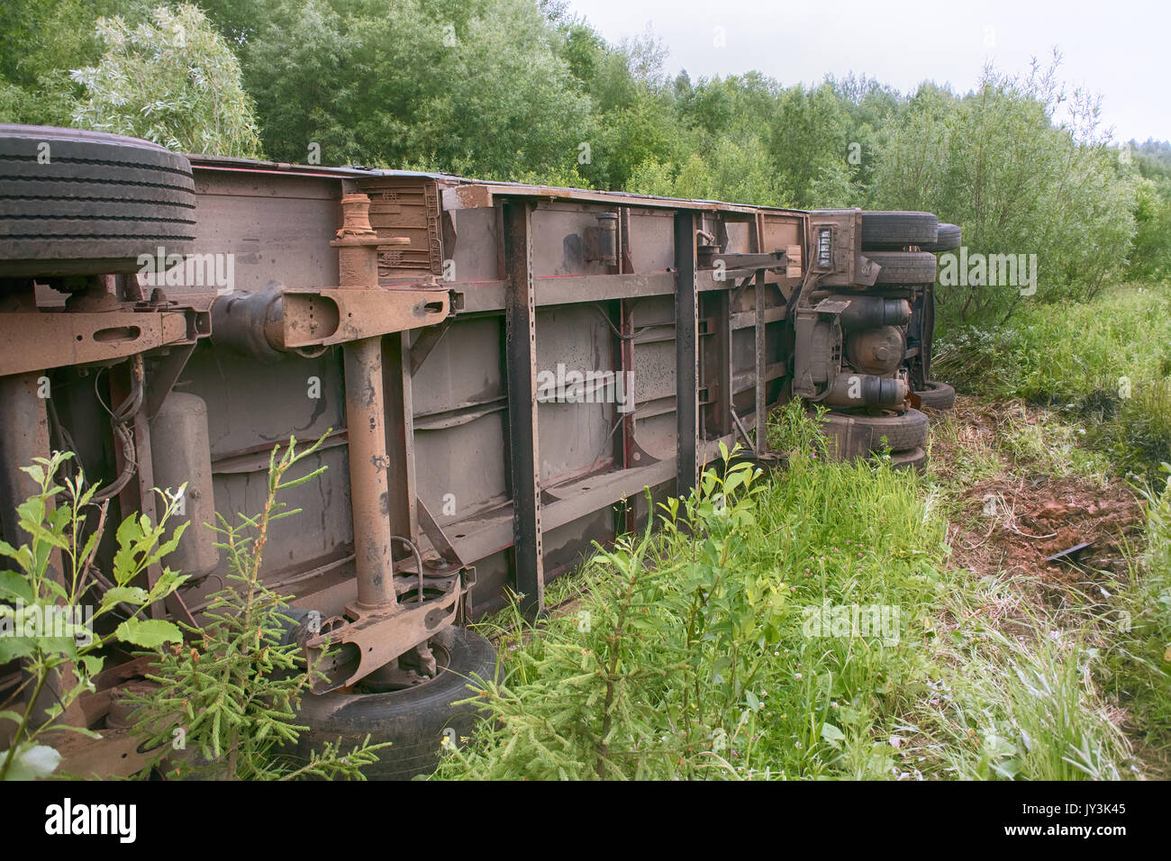 Accident on highway. Truck overturned and lying in ditch on side Stock ...
