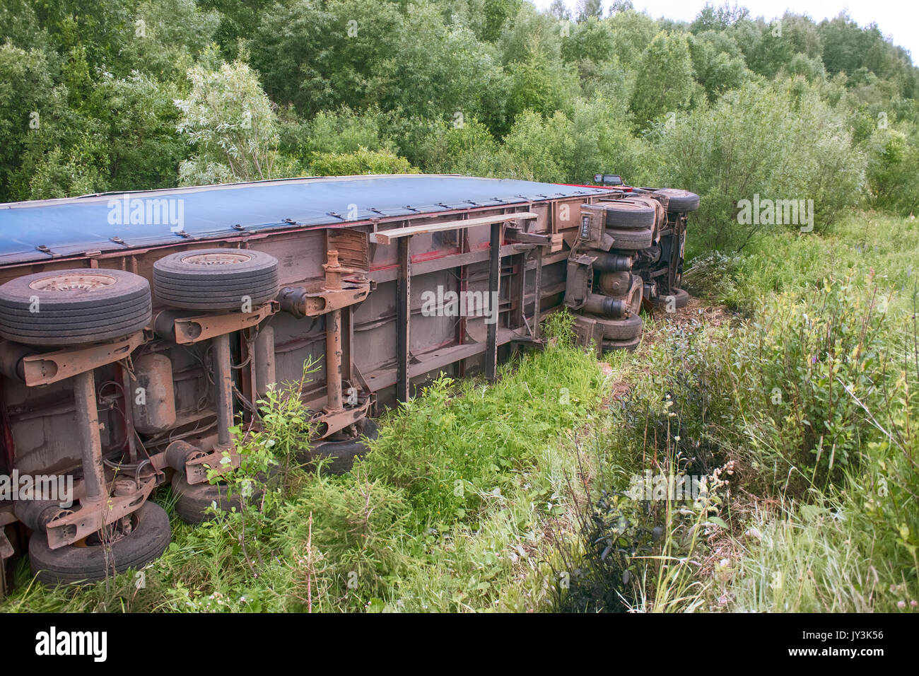 Accident on highway. Truck overturned and lying in ditch on side Stock ...