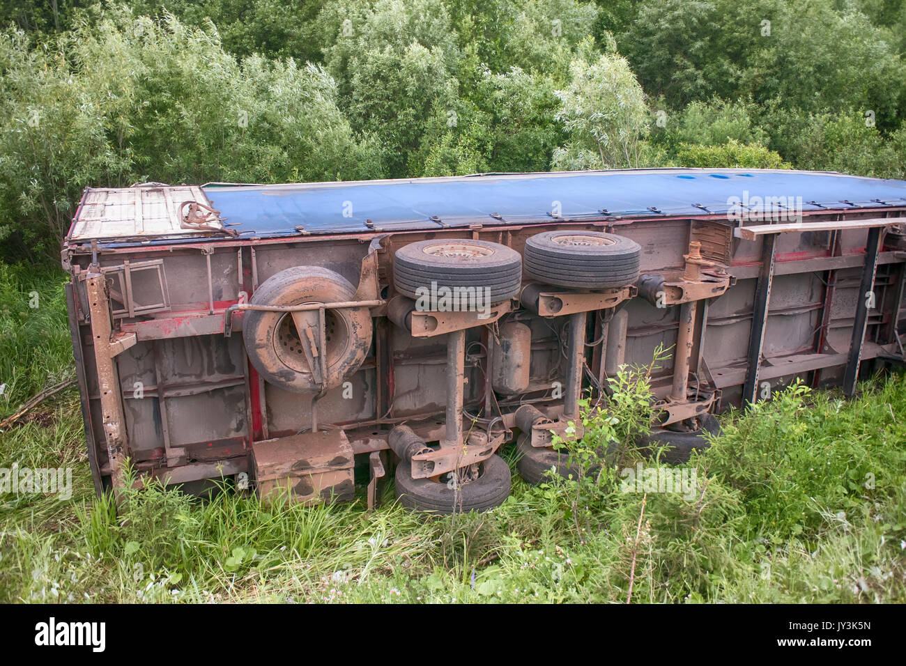 Accident on highway. Truck overturned and lying in ditch on side Stock ...