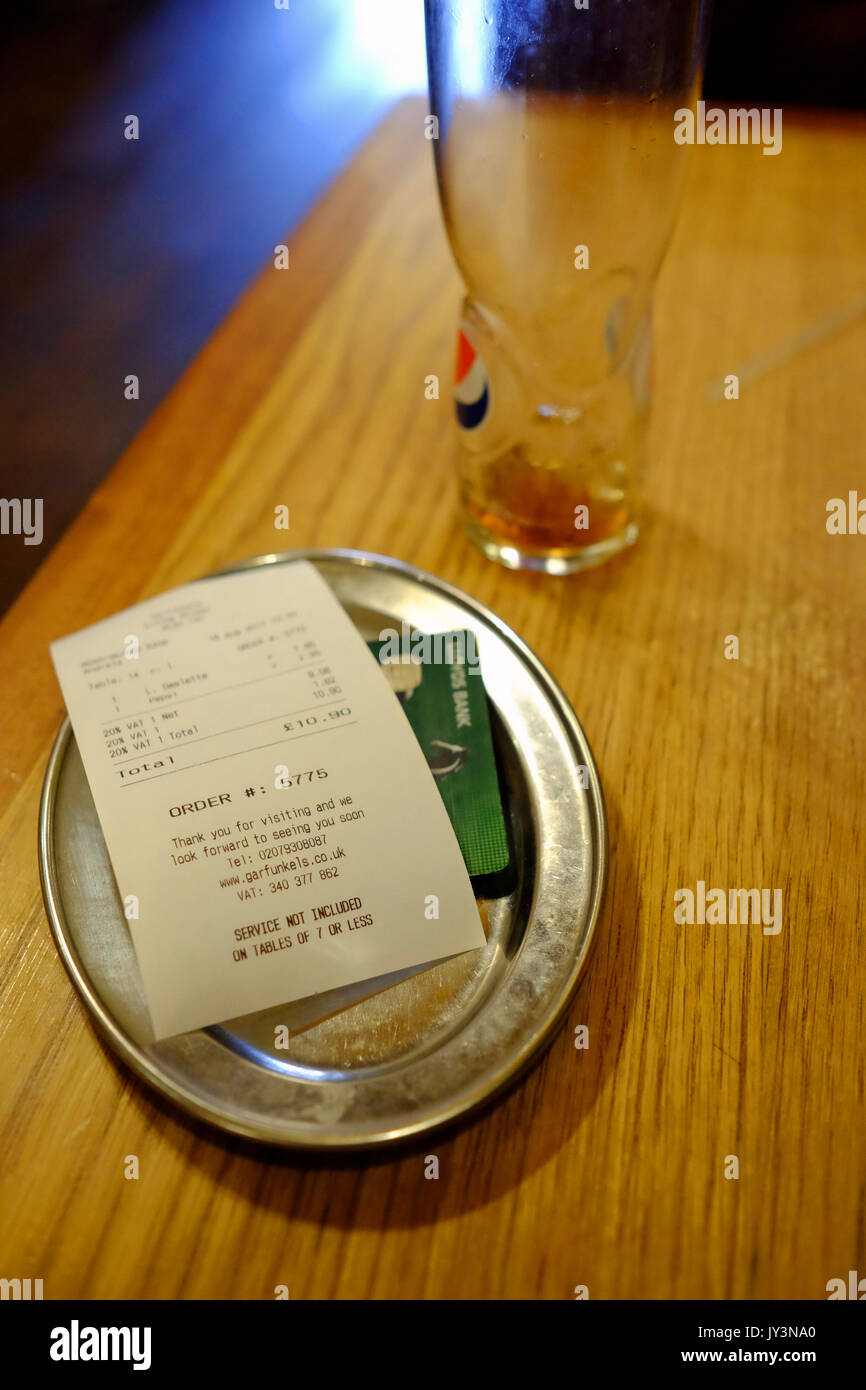 A restaurant bill and a Lloydds bank debit card for payment Stock Photo