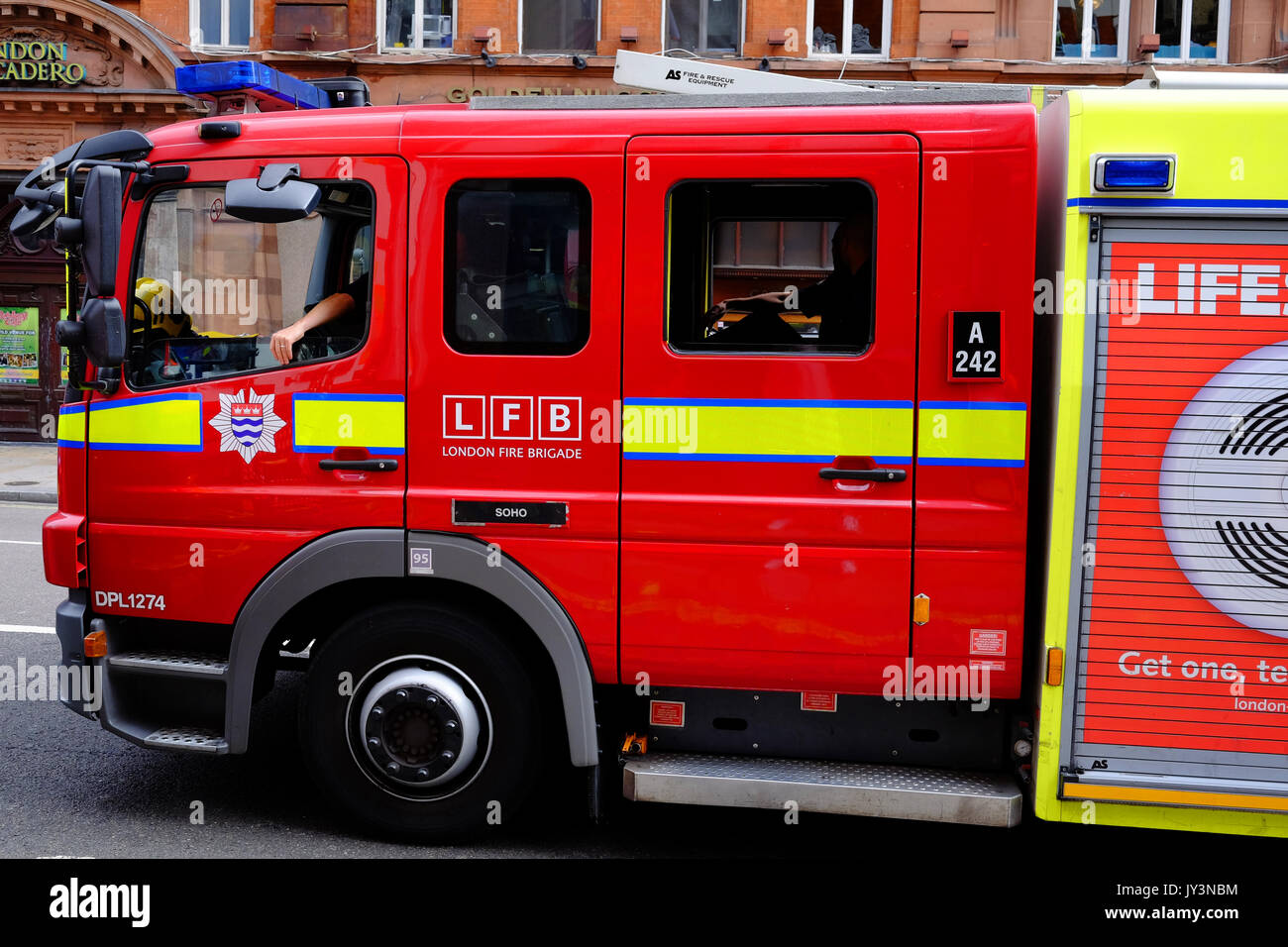 A fire engine of the London Fire Brigade returns along Shaftesbury Avene in London's West End, to Soho Fire Station Stock Photo