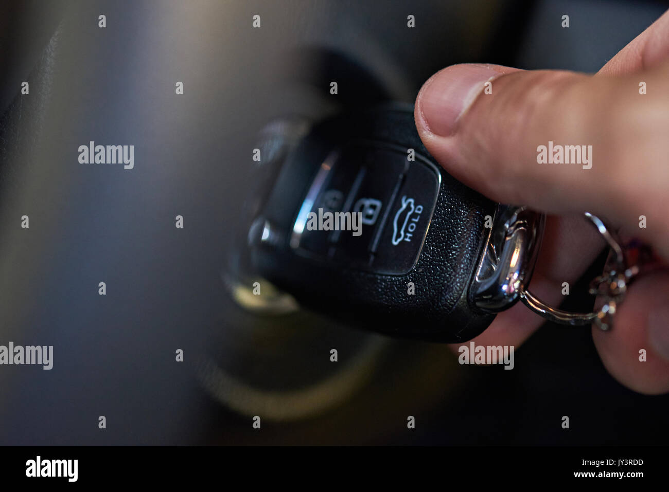 Ignition key in hand try to start car close up Stock Photo