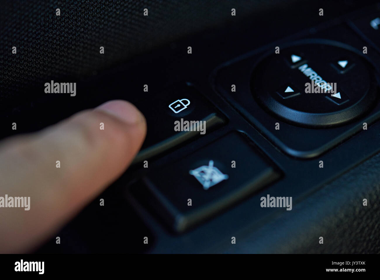 Lock car doors theme. Finger push lock button of car doors Stock Photo Alamy