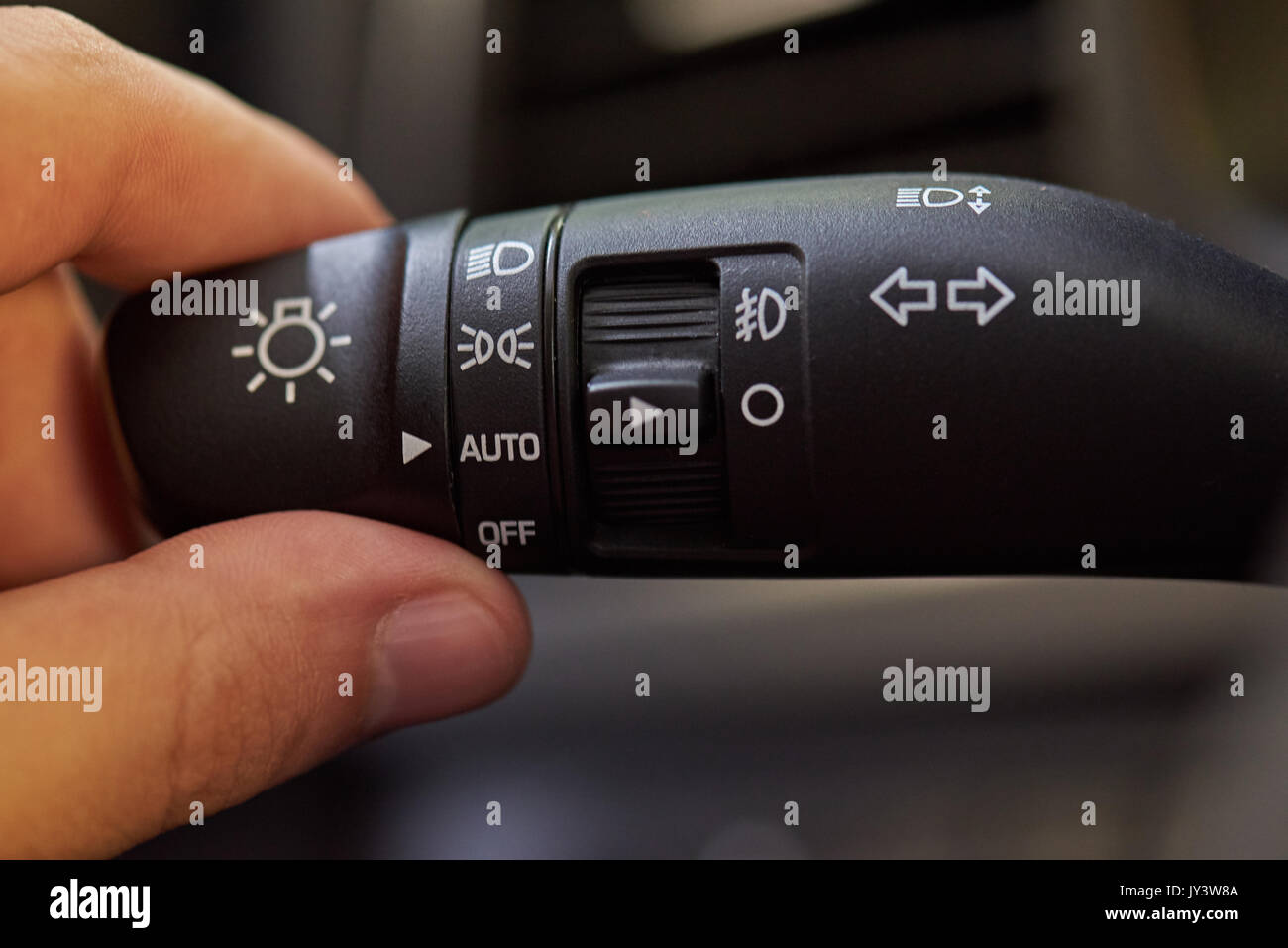 Car turn light switch handle close-up. Hand switching car light Stock Photo  - Alamy