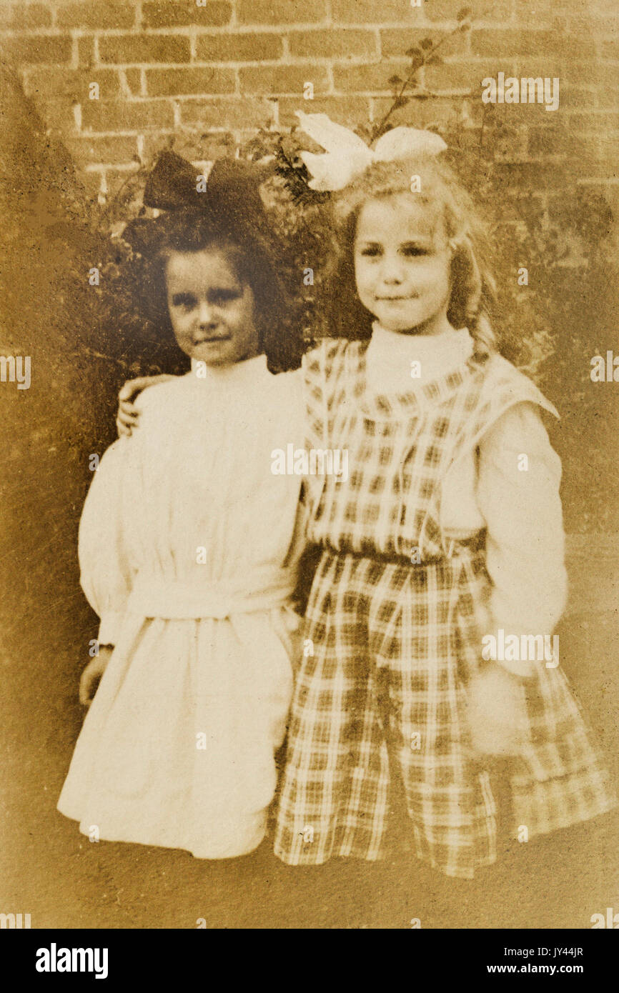 Youhg girls showing off their new clothes at the start of a new school year 1907 Stock Photo