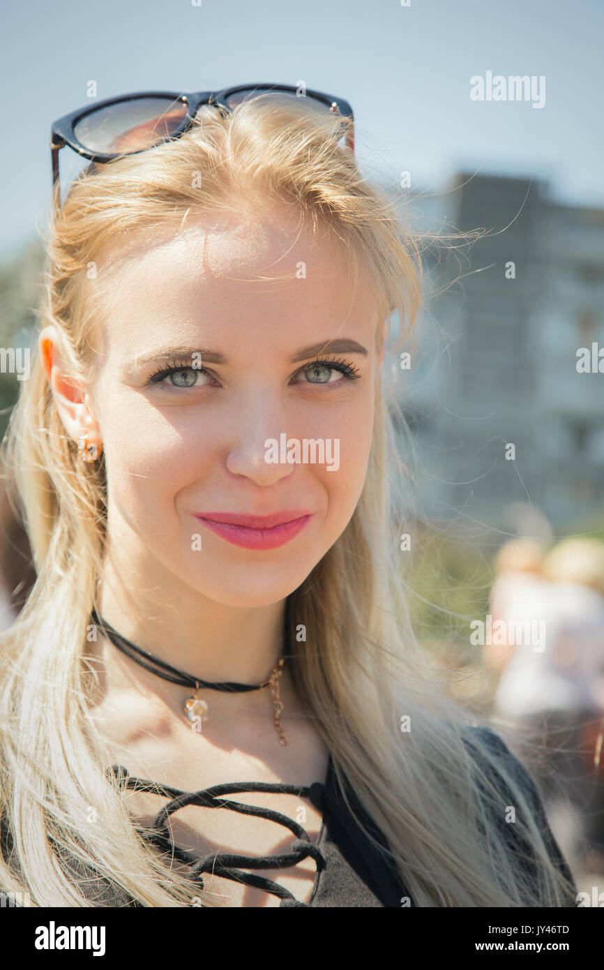 happy girl in sunlight looking at camera smiling Stock Photo - Alamy