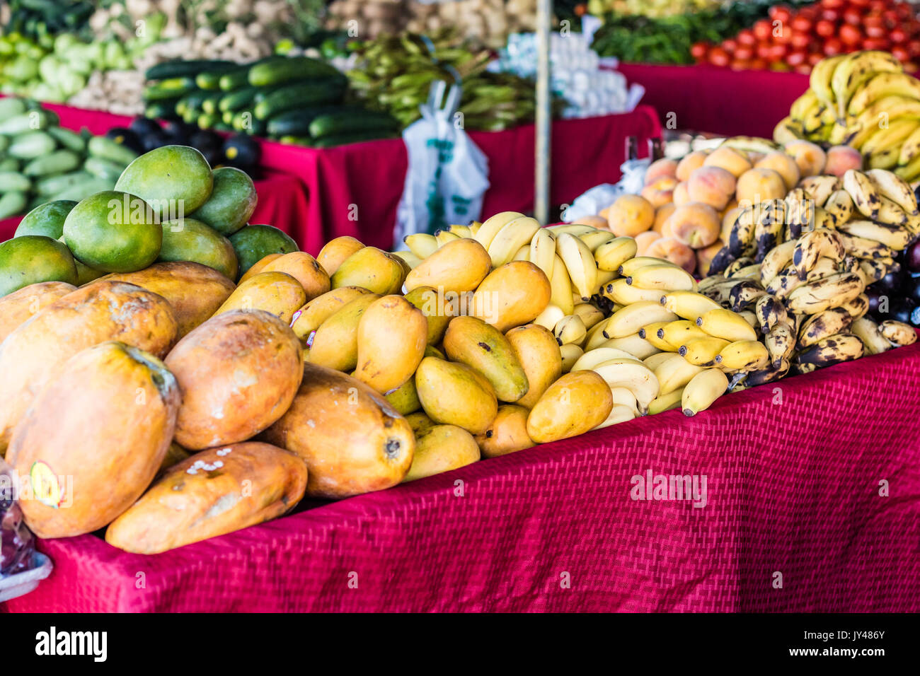 Yellow mangos and fruit displayed colorfully at a Flea Market stall Stock Photo