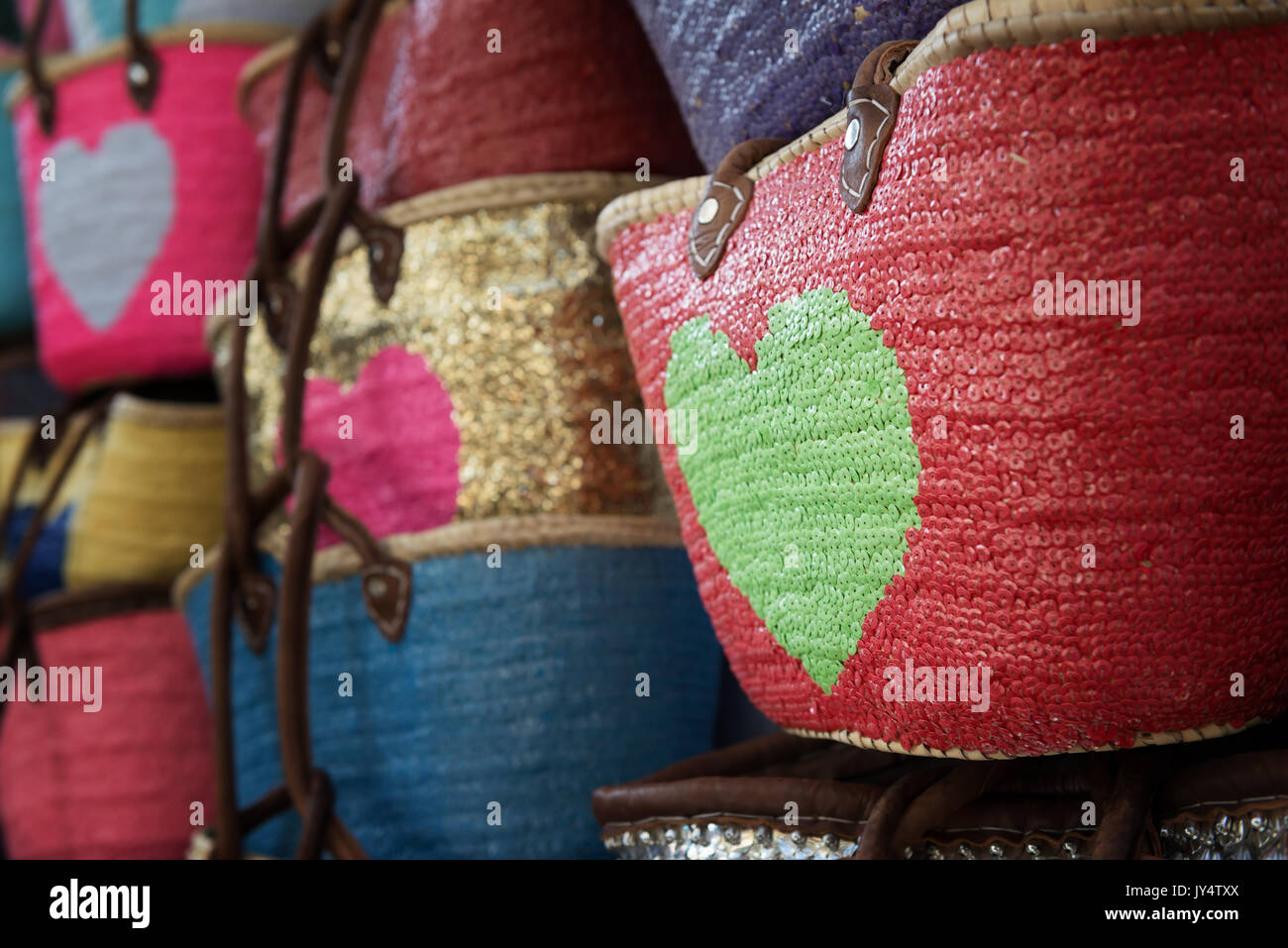Colourful fashionable shopping bags decorated with payettes. Stock Photo