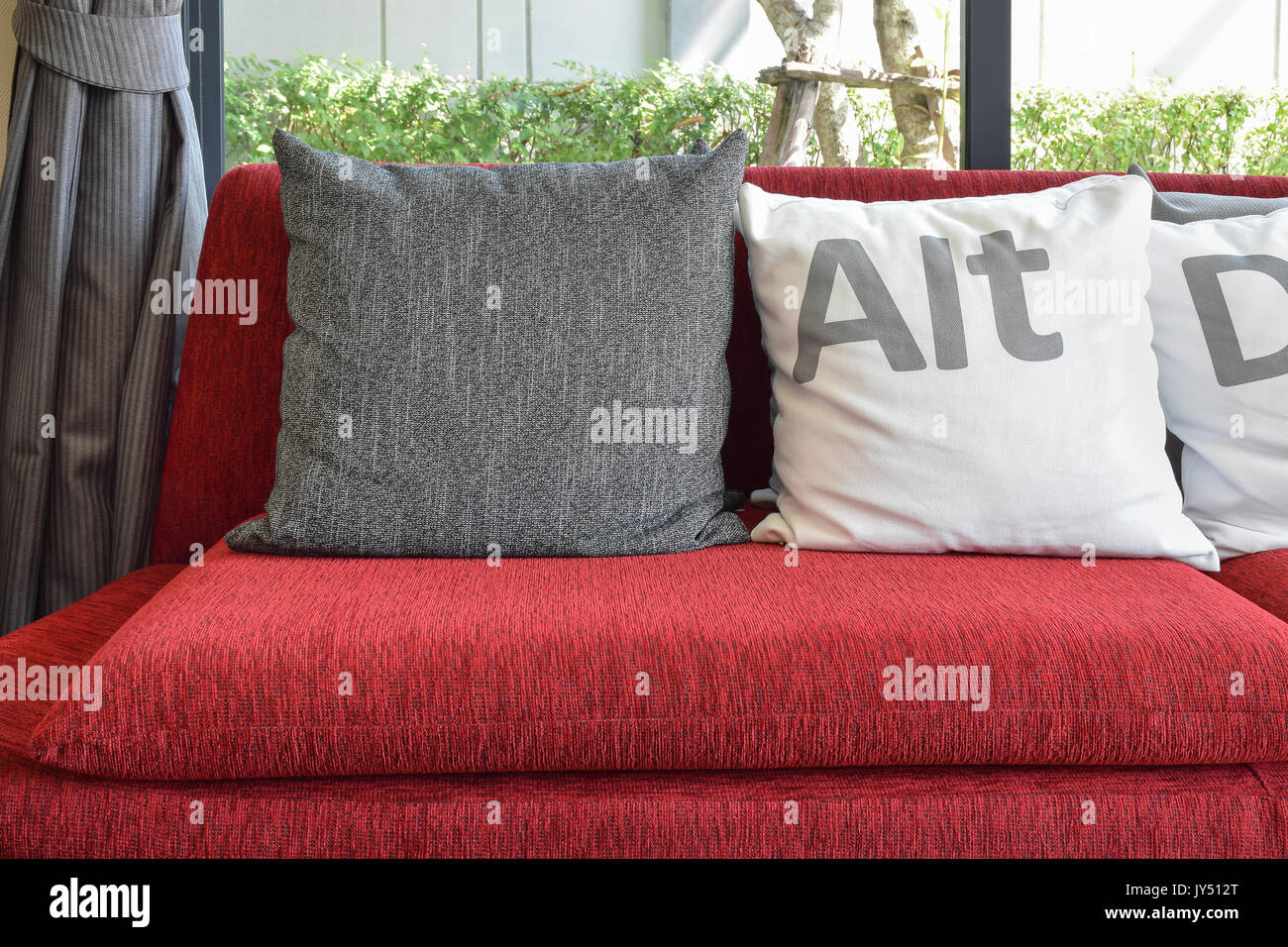 Modern Living Room Design With Pillows On The Red Sofa And