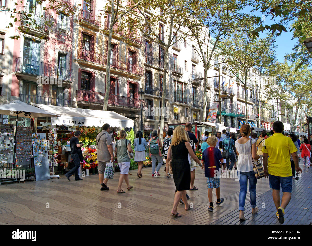The primary esplanade in Barcelona, Spain, Las Ramblas, is a pedestrian-only thoroughfare populated with tourists people watching and being watched. Stock Photo