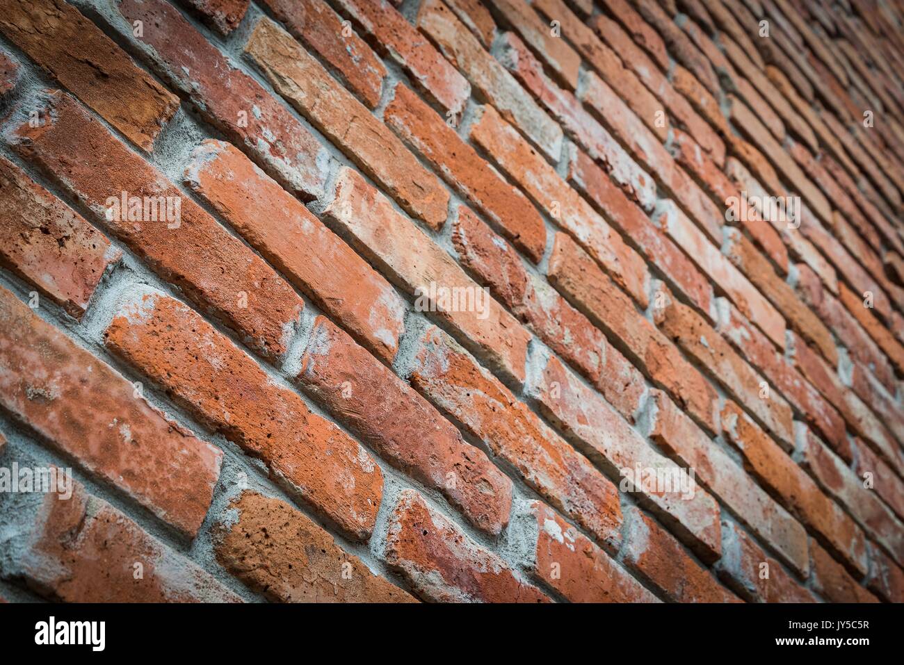 Red brick wall texture grunge background in perspective view. Selective focus Stock Photo