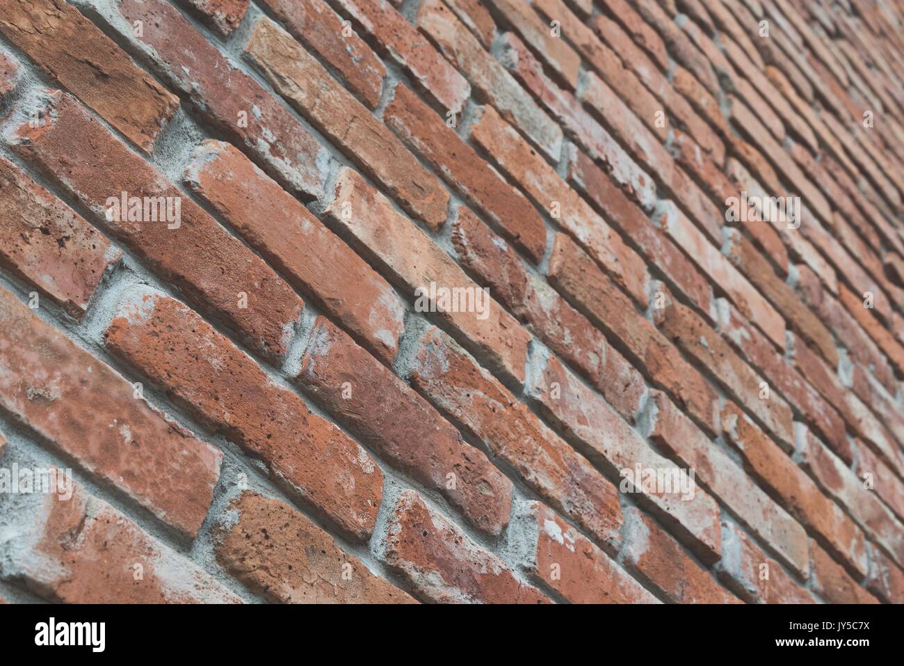 Red brick wall texture grunge background with film matt effect in perspective view. Selective focus Stock Photo