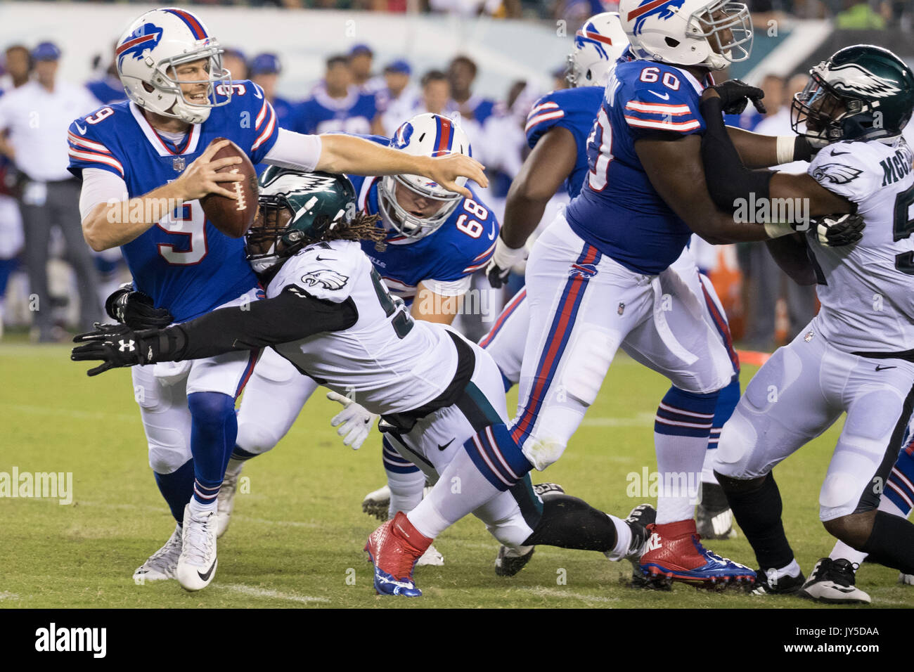 Buffalo Bills quarterback T.J. Yates (9) throws under pressure from Baltimore  Ravens defensive end Patrick Ricard (91) during the second half of an NFL  preseason game at M&T Bank Stadium in Baltimore