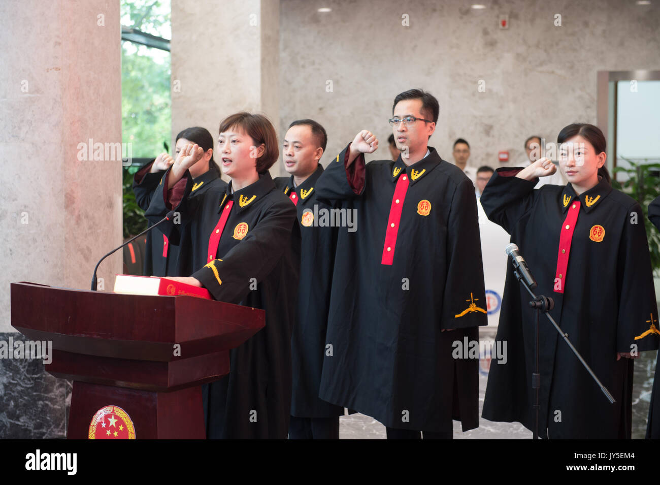 Hangzhou, China's Zhejiang Province. 18th Aug, 2017. Judges of the court swear in at a ceremony of the Internet court in Hangzhou, capital of east China's Zhejiang Province, Aug. 18, 2017. The court, first of its kind in China, specializing in handling Internet-related cases, opened Friday to cater to the increasing number of online trade disputes and copyright lawsuits. The cases handled by the court will be tried online. Credit: Weng Xinyang/Xinhua/Alamy Live News Stock Photo