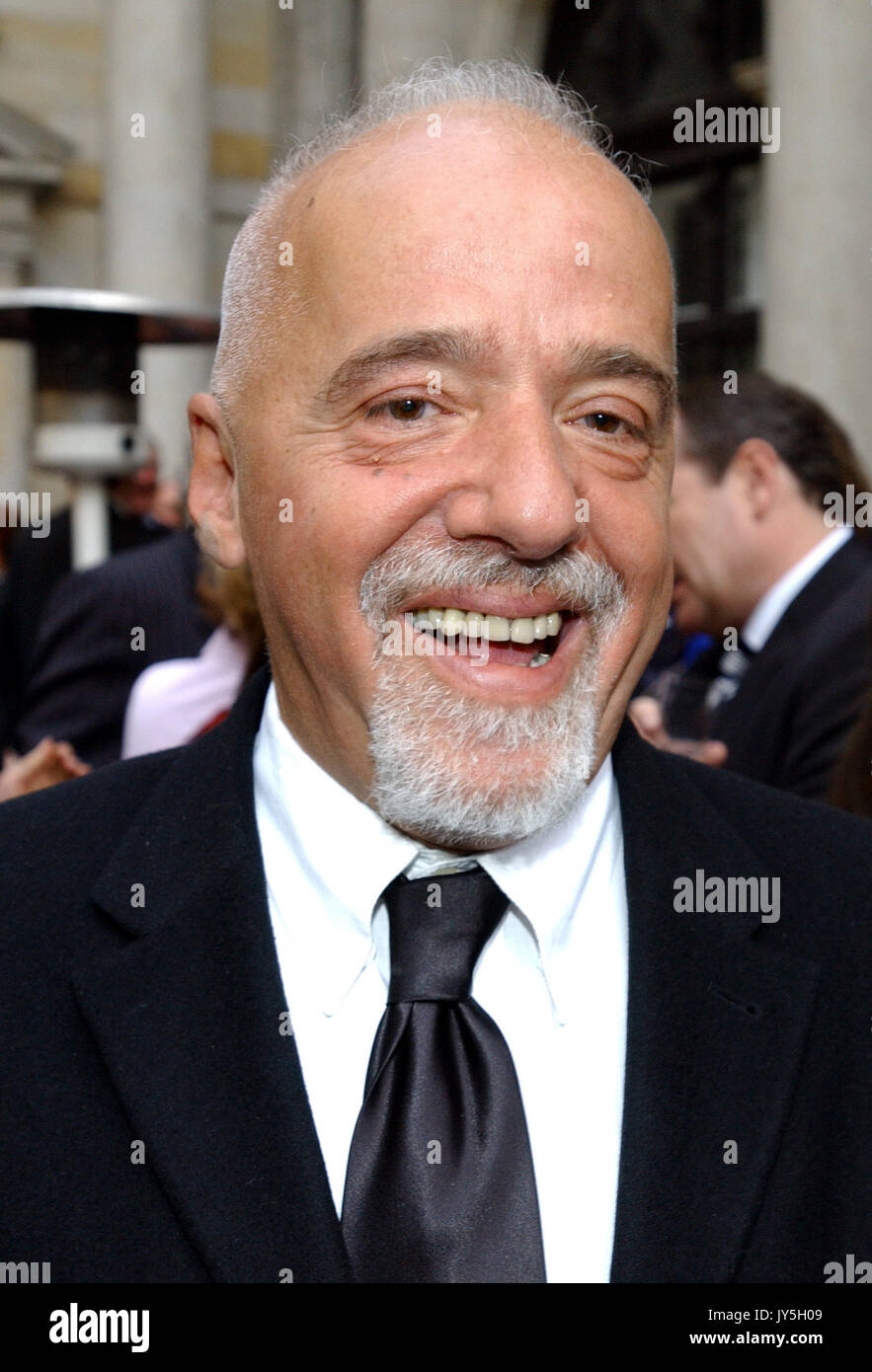 (dpa) - Brazilian author Paulo Coelho smiles as he arrives for the award ceremony at the chamber of commerce in Hamburg, Germany, 19 May 2005. Coelho received the 'Goldene Feder' (golden feather) media prize in the category 'honourary prize', which is being awarded by the Heinrich-Bauer publishing house. | usage worldwide Stock Photo