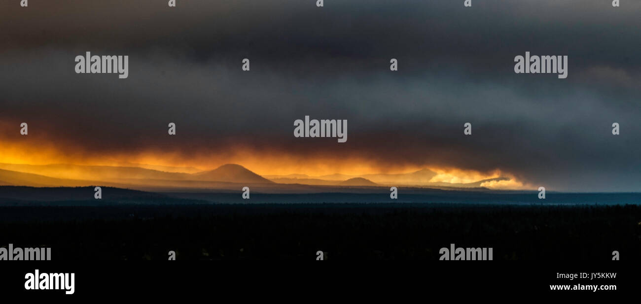 Oregon, USA. 17th August, 2017. Smoke from the Mill Fire just west of the town of Sisters and northwest of Bend, Oregon, flows over the Cascade Mountain Range, threatening views of the upcoming solar eclipse Credit: Robert Bush/Alamy Live News Stock Photo