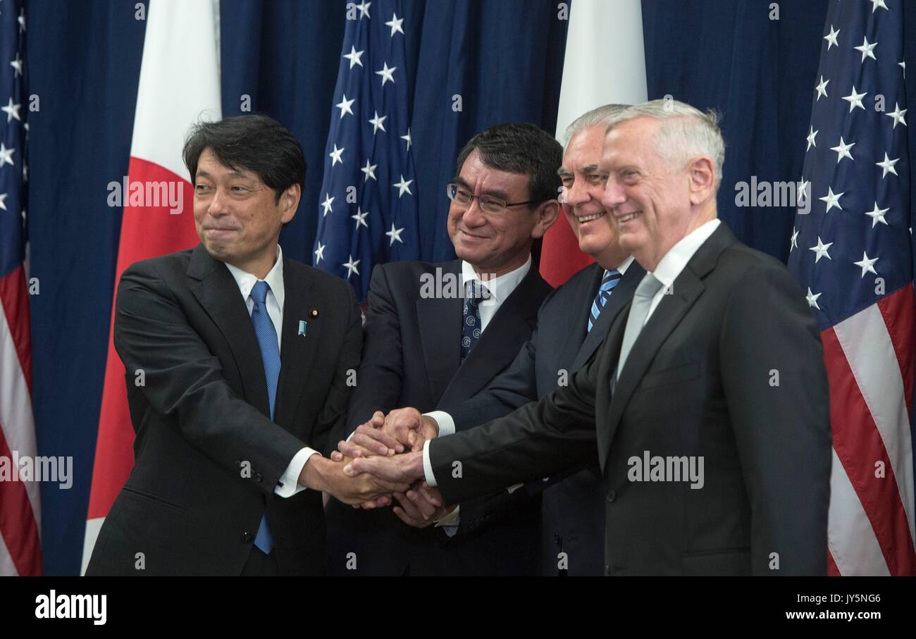 U.S. Secretary of State Rex Tillerson, center, U.S. Defense Secretary Jim Mattis, right, joins hands with Japanese Foreign Minister Taro Kono, center, and Japanese Defense Minister Itsunori Onodera, left, for the start of the U.S.-Japan Security Consultative Committee meetings at the Department of State August 17, 2017 in Washington, D.C. Stock Photo