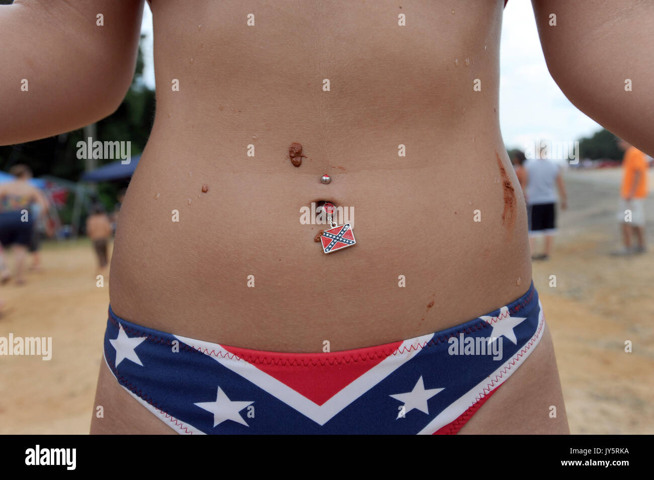 East Dublin, Georgia, USA. 11th Mar, 2008. Megan Lever sports a Confederate Battle Flag navel ring while attending the 13th annual Summer Redneck Games at Buckeye Park in East Dublin, Georgia, on Saturday. The annual homage to Southerners, began as a spoof to the 1996 Summer Olympics in Atlanta. Thousands of revelers attend the event whose events include bobbing for pigs feet, the mud pit belly flop and armpit serenade. (Credit Image: © Erik Lesser/ZUMA Press) Stock Photo
