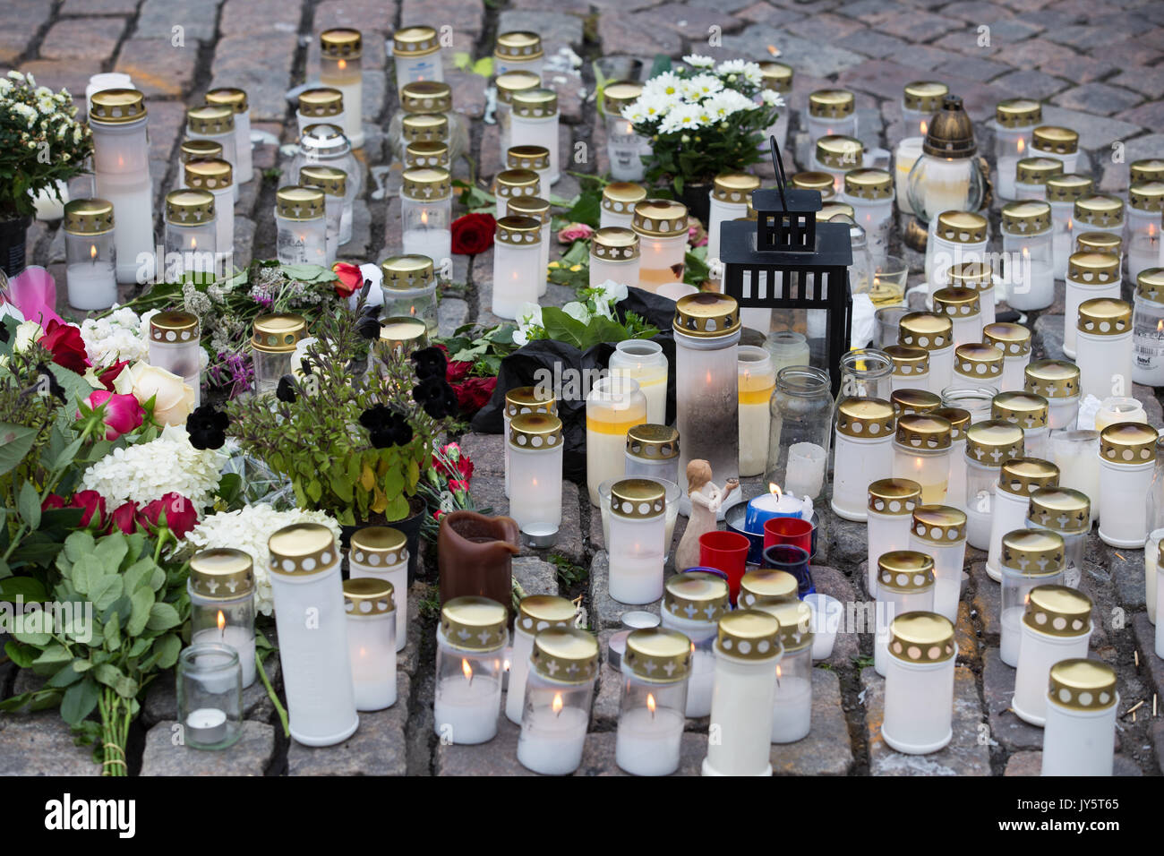 Turku, Finland. 19th of August 2017. Candles and flowers for the victims of knife attack in Turku market square. Two people have been killed and six others wounded in a knife attack that took place on friday 18th of august at Turku market square and Puutori. The police was able to stop the attacker within minutes after the first emergency call by shooting him at thigh. Police is investigating the attack as an act of terrorism. Credit: Jarmo Piironen/Alamy Live News Stock Photo