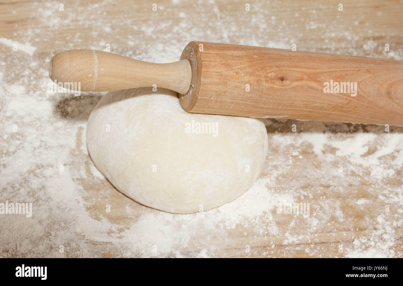 dough ball, wheat flour and roll in the kitchen working table for baking bread Stock Photo