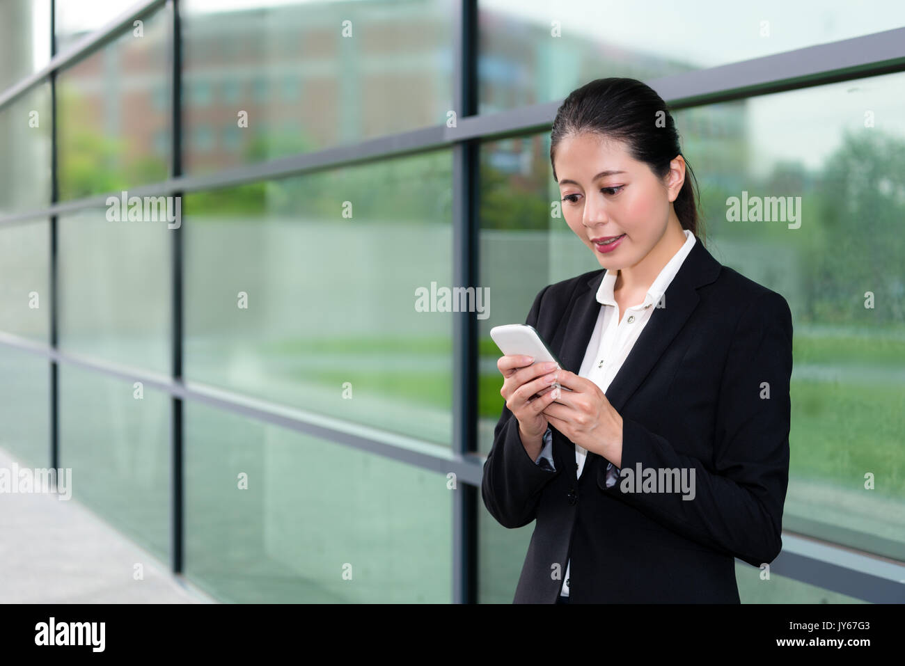 elegant office worker girl using mobile cell phone to contact company