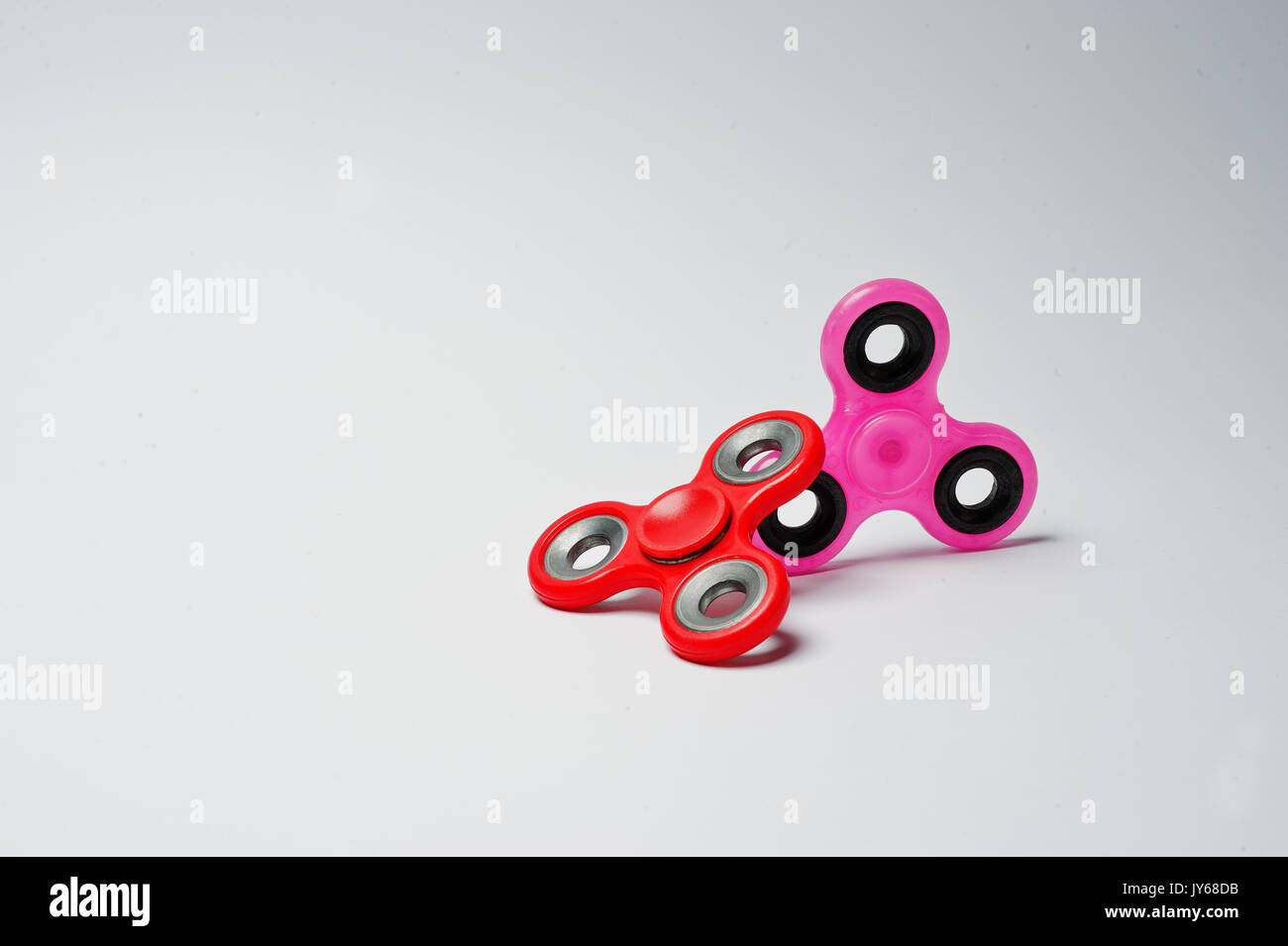 Closeup photo of two fidget spinners on a white background Stock Photo