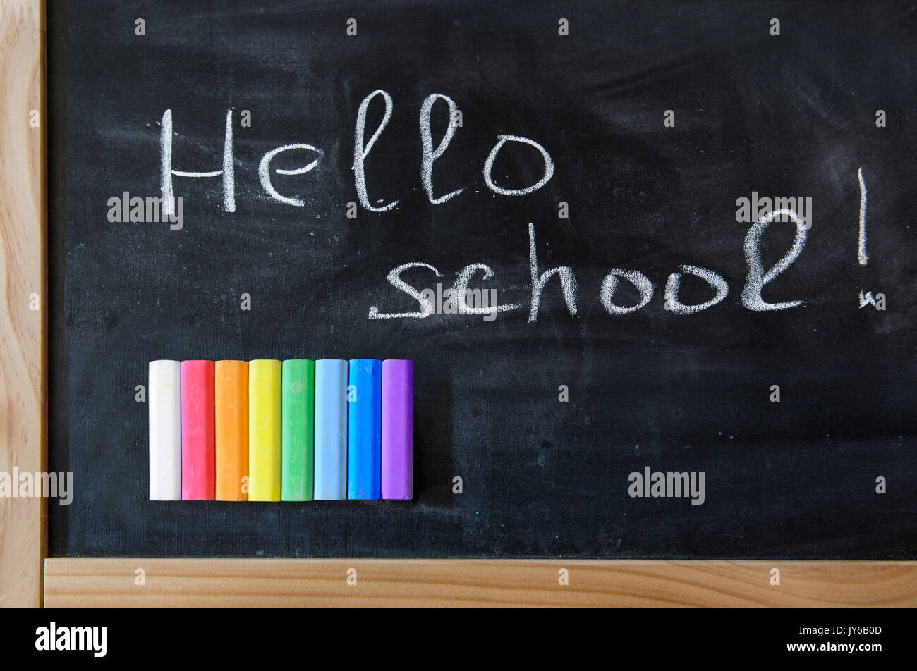 School board with a set of colored crayons. All colors of the rainbow Stock Photo