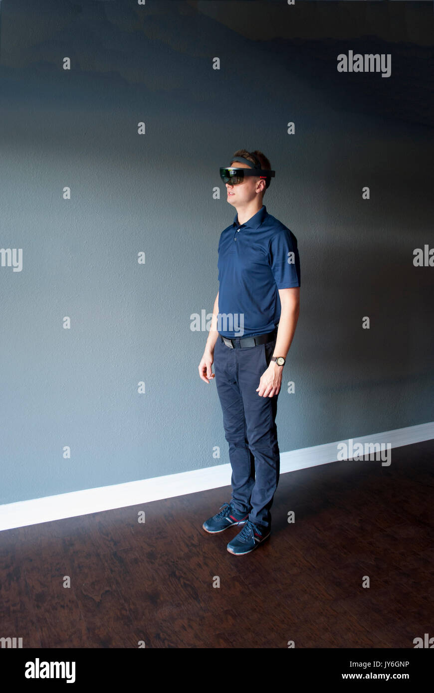 Young engineer in holographic headset creating a virtual surrounding using special gestures - gaze Stock Photo