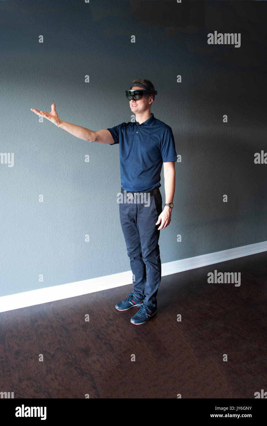 Young engineer in holographic headset creating a virtual surrounding using special gestures - gaze Stock Photo