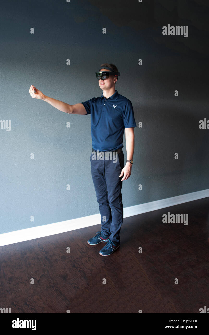 Young engineer in holographic headset creating a virtual surrounding using special gestures - gaze Stock Photo