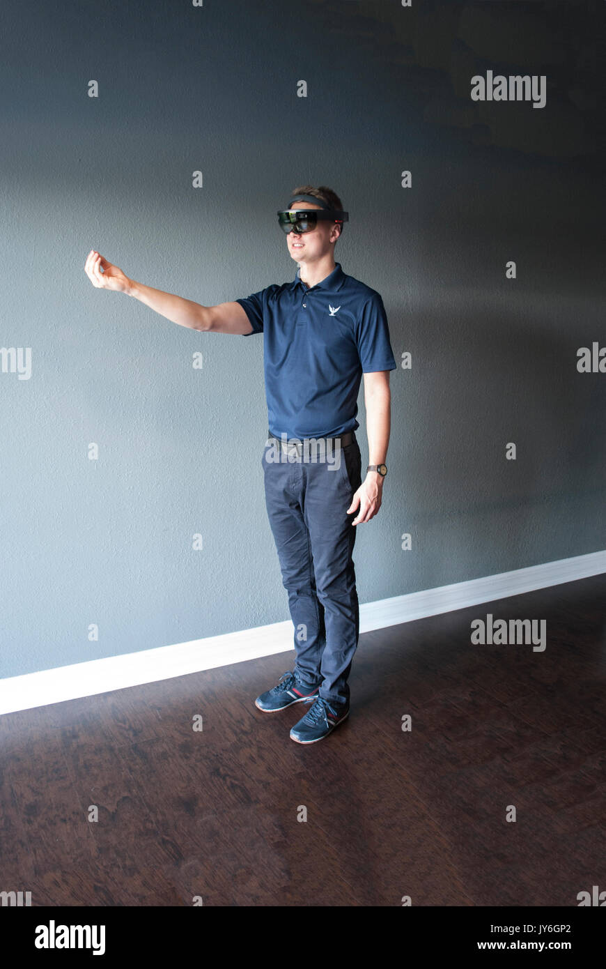 Young engineer in holographic headset creating a virtual surrounding using special gestures - gaze Stock Photo