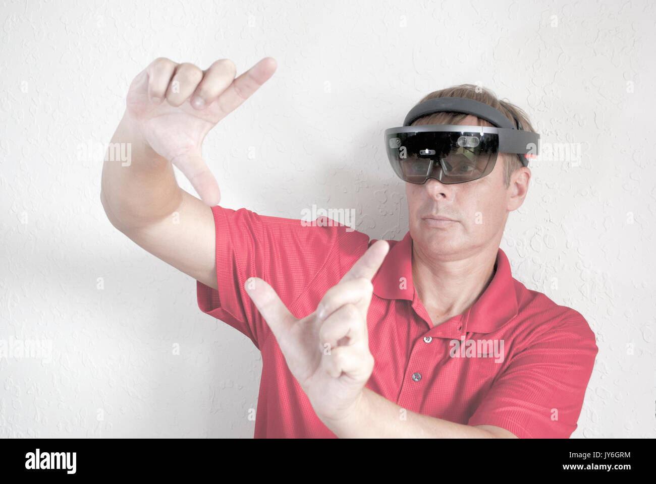 man working with holographic head set mixing reality Stock Photo