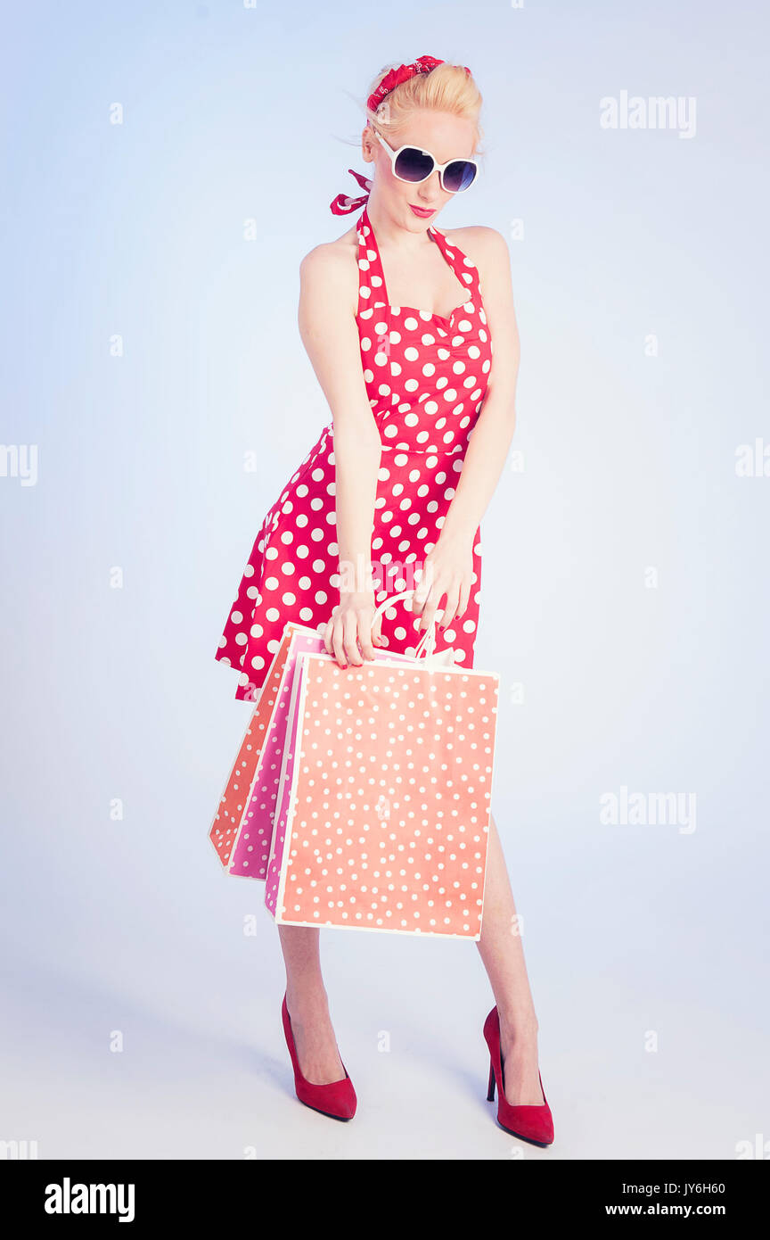 Retro pin up girl shopping. Woman holding paper bag Stock Photo