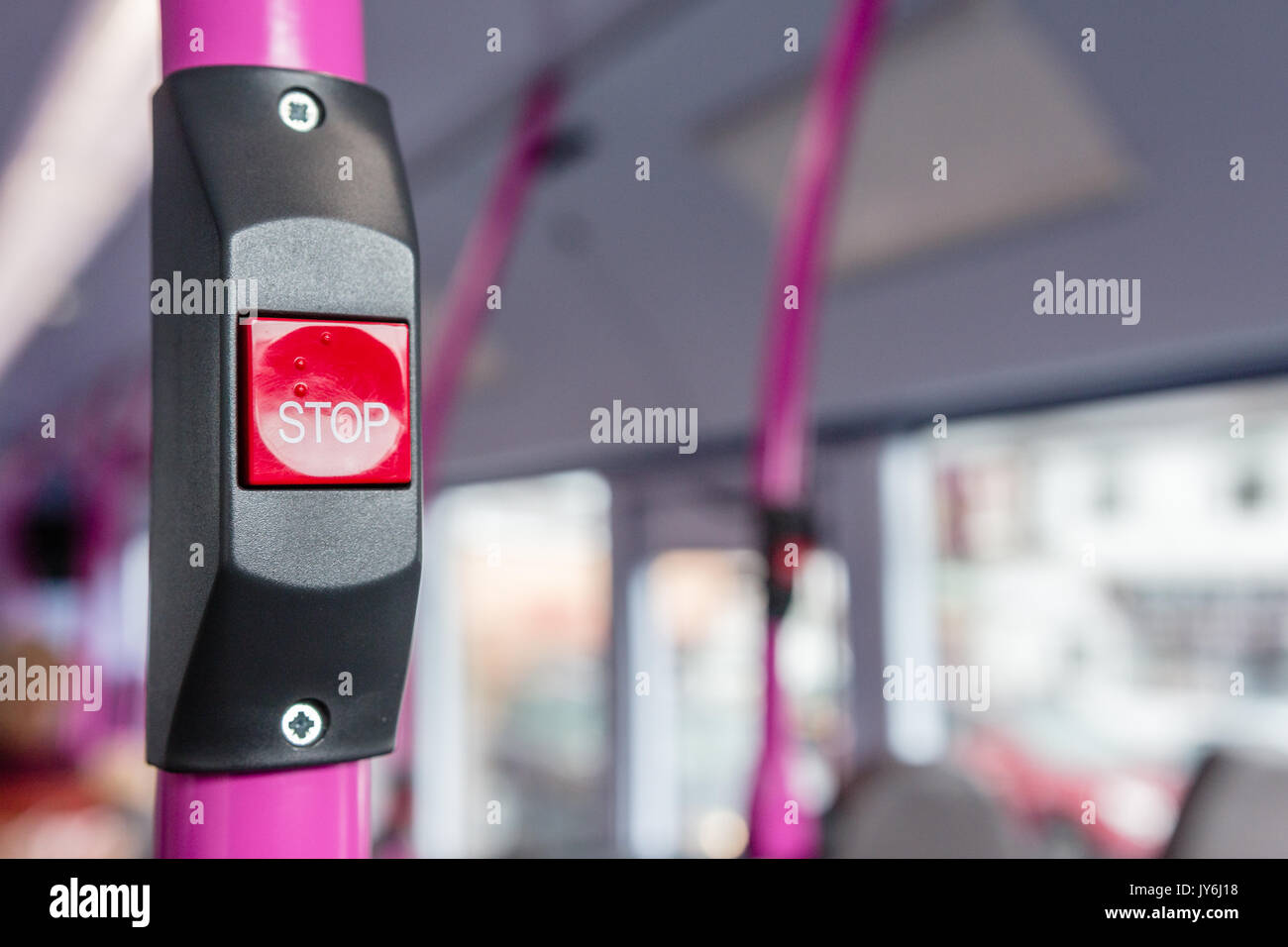 Bus stop button with empty bus in background Stock Photo - Alamy