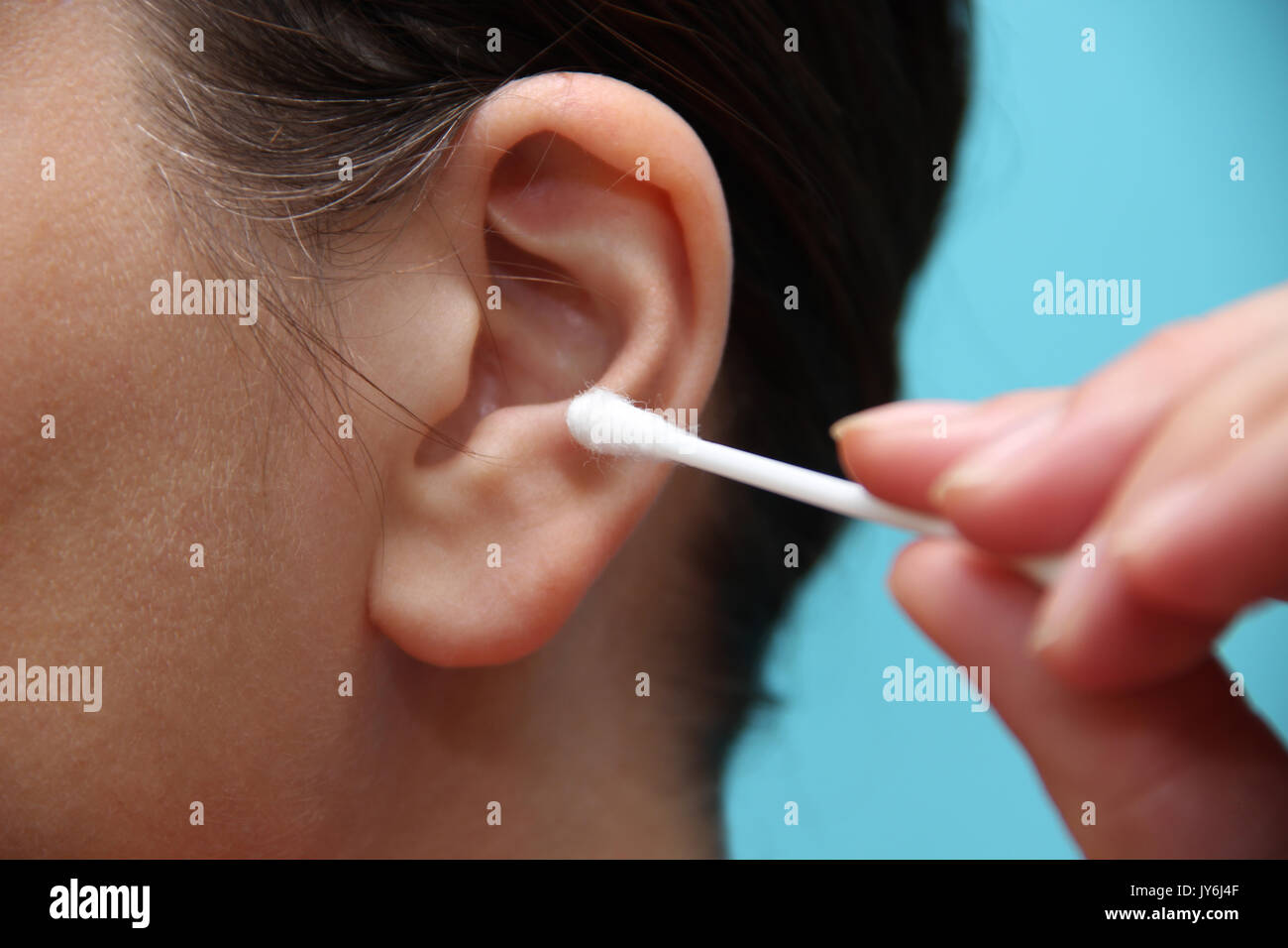 Woman cleaning ear with cotton swab Stock Photo Alamy
