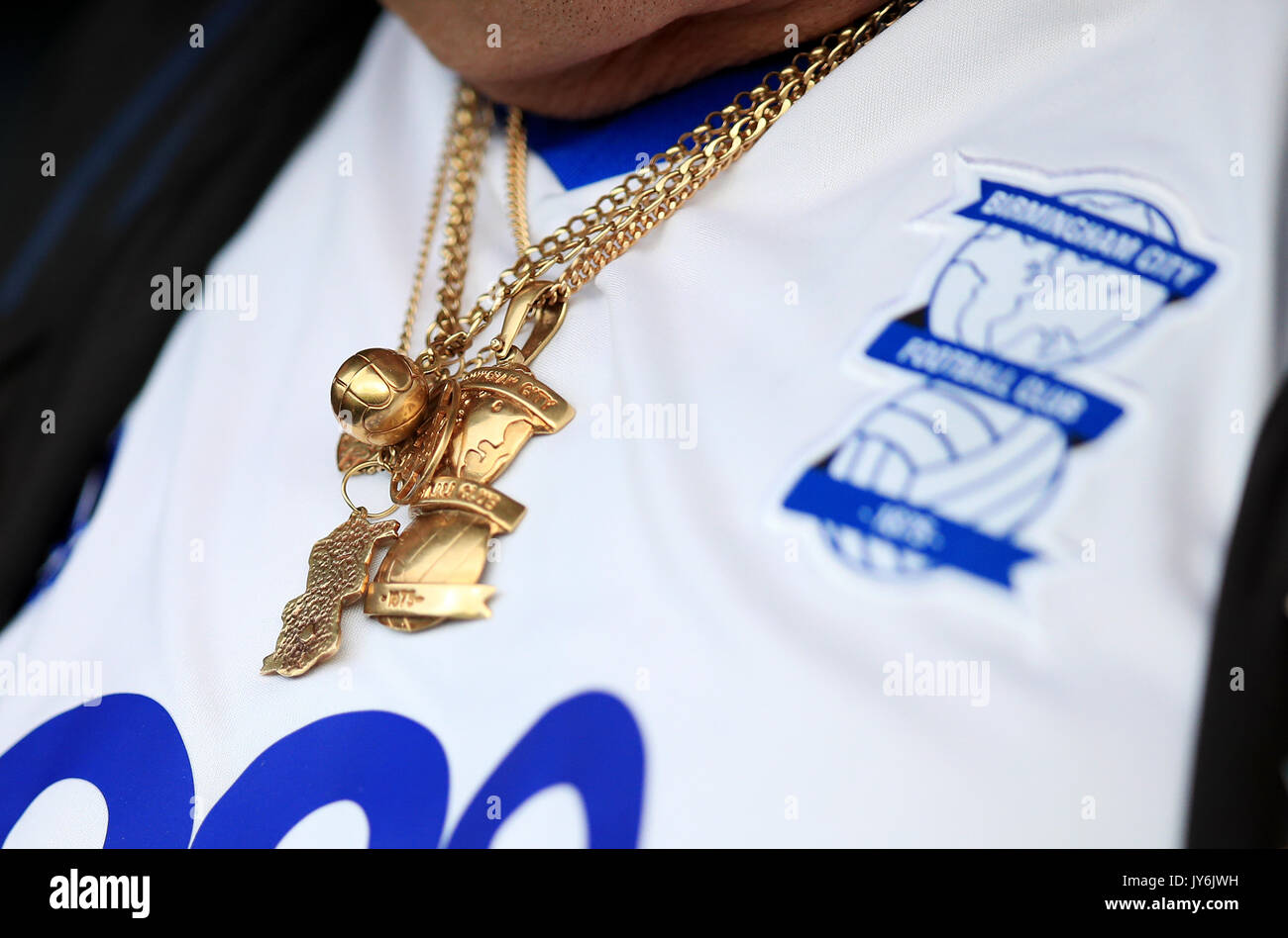 A Birmingham City fan wearing an away shirt and matching jewellery